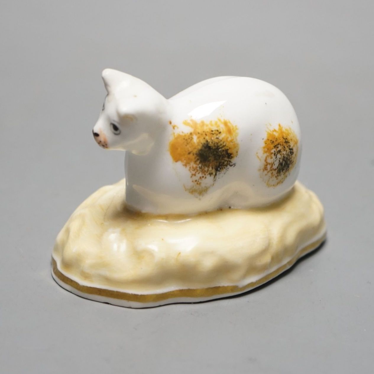 A rare Samuel Alcock porcelain model of a recumbent cat, circa 1835-50, impressed ‘6’, Cf. Dennis G. Rice, cats in English porcelain, colour plate 36., 7cms wide at base., Provenance: Dennis G. Rice collection.
